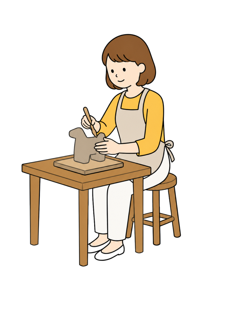 粘土で立体作品を造形する成人女性