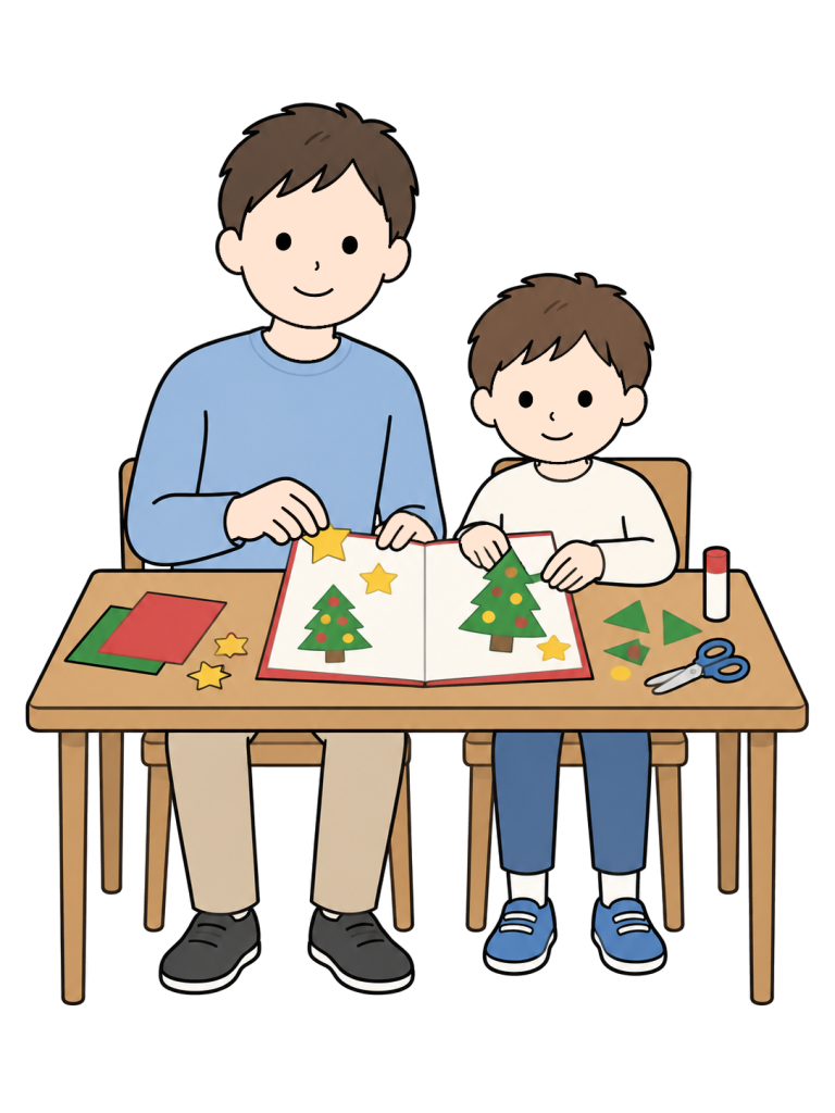 A man and a boy attach paper trees to an open Christmas card at a table with colored paper and craft supplies.